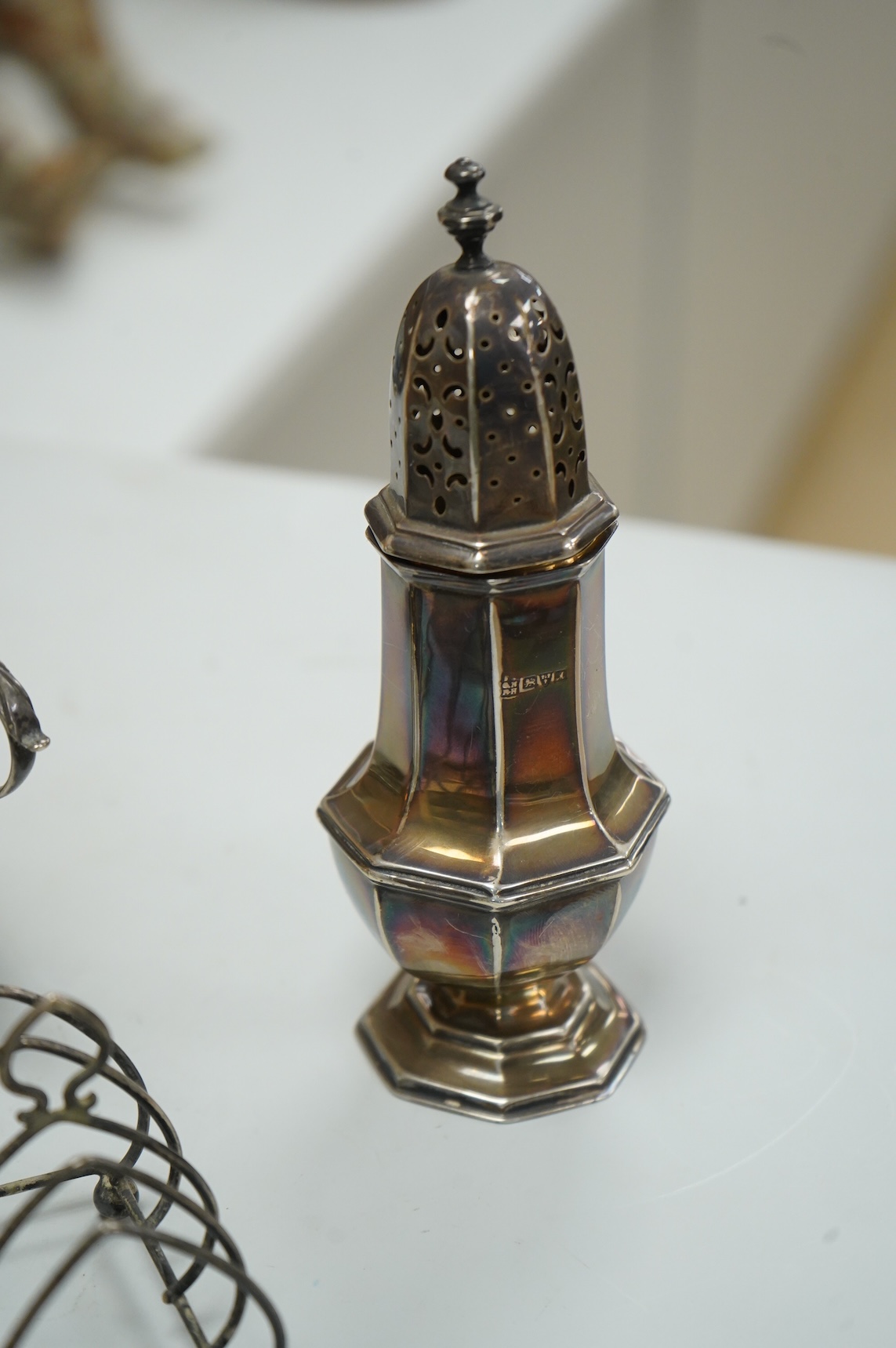 A collection of small silver, including a George III cream jug, London, 1762, 88mm, a George V sugar caster, small five bar toastrack, pair of bonbon dishes, pepperette, dish, two condiment spoons and mustard pot, togeth